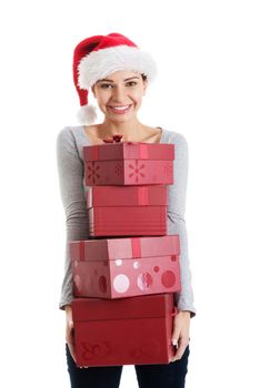 Beautifull woman in santa hat holding presents. Isolated on white.