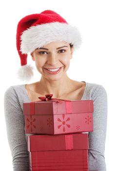 Beautifull woman in santa hat holding presents. Isolated on white.