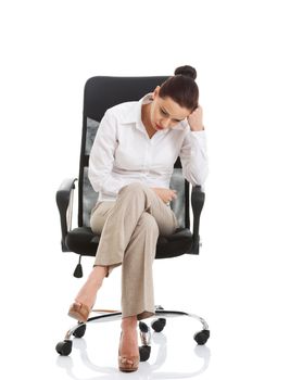 Beautiful sand business woman sitting on a chair. Isolated on white.