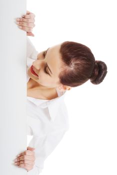 Beautiful young business woman holding copy space. Isolated on white.