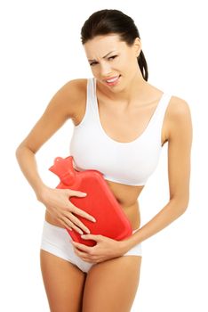 Beautiful slim woman holding hot water bottle on her belly. Isolated on white.