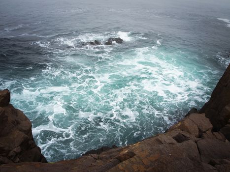 Storm Sea With Dark Rocks in Bad Weather Time