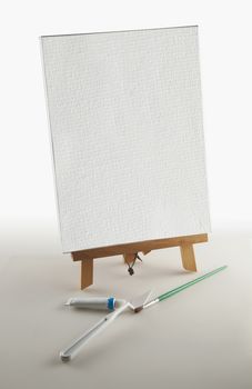 Blank canvas and instruments for painter over white background
