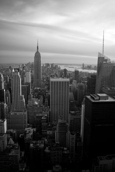 Skyline vew of the Manhattan section of New York City in black and white around dusk.