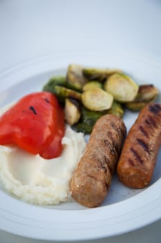 BBQ grilled sausages with mash potatoes and vegetables