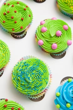 Colorful decorated cupcakes in a white box