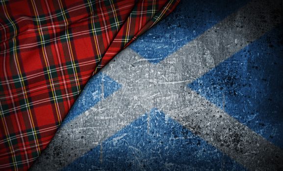 tartan textile on stone background with scotland flag