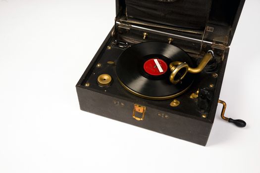 An old battered record player audio device that closes like a suitcase