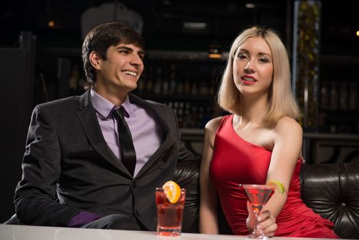 Young couple talking in a nightclub, have fun