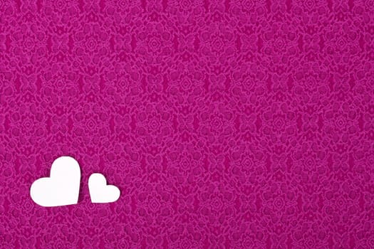 Pink material with two hearts, a textile background, Valentines Day.
