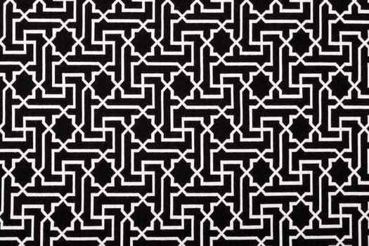 Material in geometric patterns, a black and white textile background.