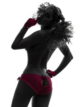 one caucasian sexy woman topless with pink underwear hushing in silhouette studio isolated on white background