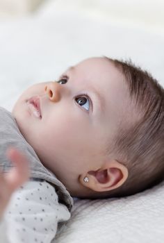 Happy cute baby girl lying on back