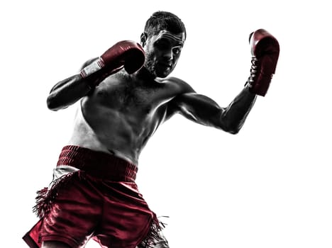 one caucasian man exercising thai boxing in silhouette studio on white background