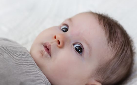 Happy cute baby girl lying on back