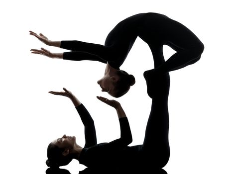 two women contortionist practicing gymnastic yoga in silhouette  on white background