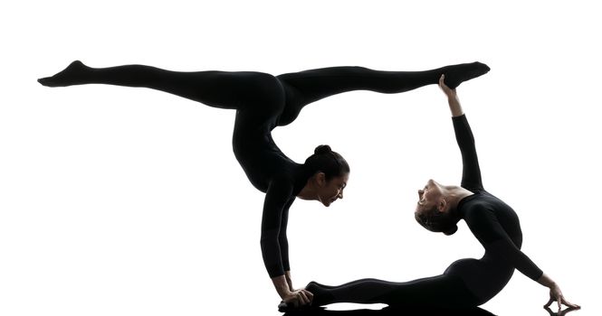 two women contortionist practicing gymnastic yoga in silhouette  on white background