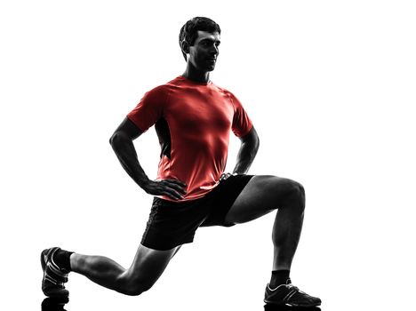 one man exercising fitness workout lunges crouching in silhouette on white background