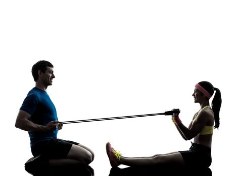 one woman exercising resistance rubber band fitness workout with man coach in silhouette on white background