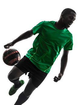 one african man soccer player green jersey juggling in silhouette on white background