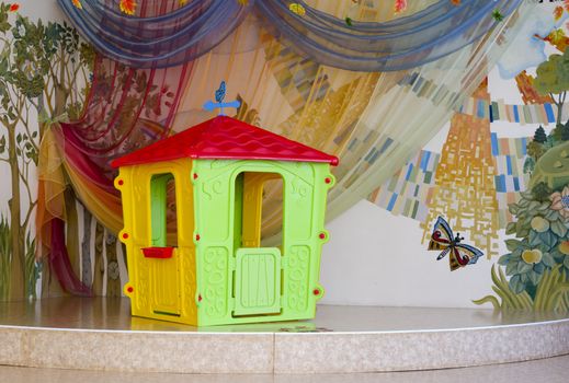 The Isolated plastic children's playhouse on black background on beautifully designed stage
