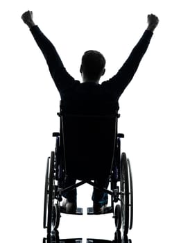 one handicapped man arms raised rear view in silhouette studio on white background