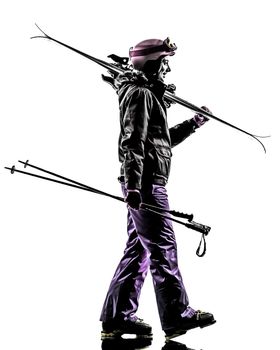 one caucasian woman skier walking side view in silhouette on white background