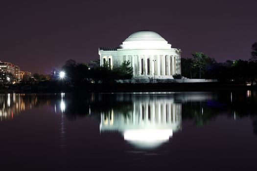 Thomas Jefferson Memorial silhouette at night with mirror reflection on water, Washington DC United States