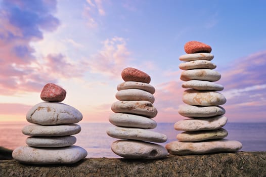 Balancing of white and red piles of pebbles on the seacoast