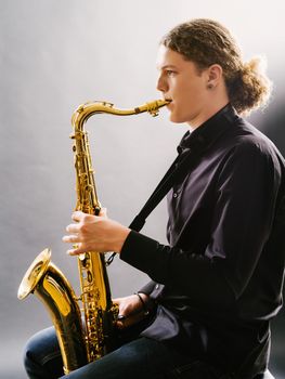 Photo of a teenager playing the saxophone.