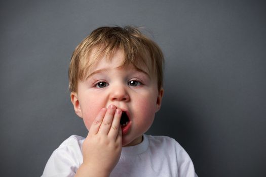 Little boy upset or hurting, toothache or other booboo concept.