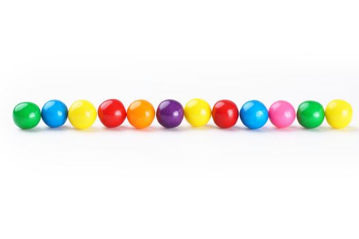 Colorful gumballs border over white background