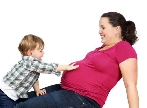 Cute little blond boy touching his pregnant mother belly