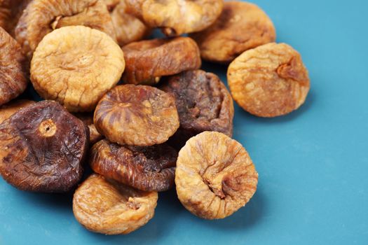 Heap of dried figs on blue plate