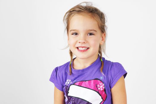 Portrait of sweet and cute happy little blond girl 