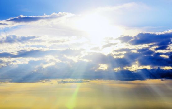 Beautiful early sunset sky with sunrays piercing through the clouds with bokeh