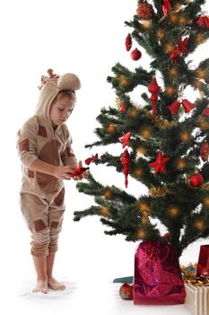 Boy in giraffe costume near Christmas tree isolated on white