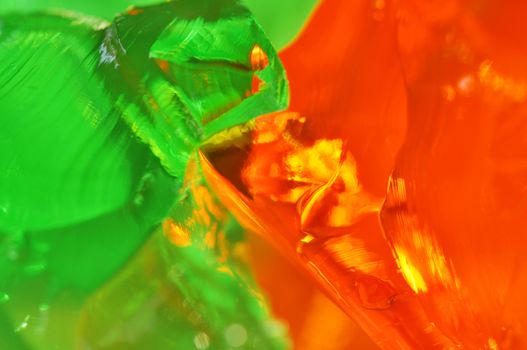 Macro of green lime and orange jelly or gelatin, fun abstract food background