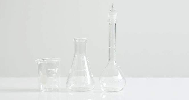 Laboratory glassware on white, stark and sterile concept