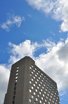 Dark grey high rise building and sky with copy space