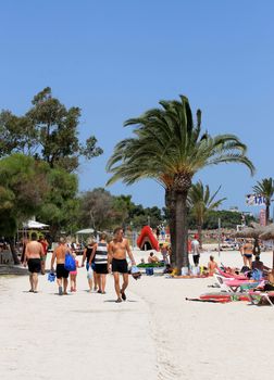 ALCUDIA BEACH, MAJORCA, SPAIN - 7th August 2013: Alcudia Bay beach on the 7th August 2013. Families enjoying their family vacation to this popular resort.
