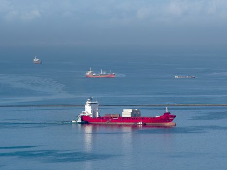 big red container ship in the ocean