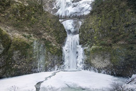 Bridge with People Faces Blurred Over Multnomah Falls at Columbia River Gorge Oregon Frozen in Winter Season