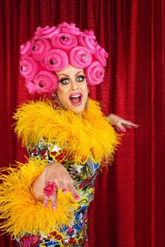 Happy dancing drag queen in pink foam wig