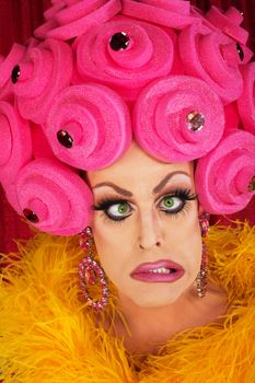 Cross eyed man in drag with plastic foam wig