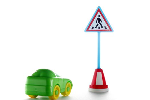 Green car behind Pedestrian crossing road sign on white background
