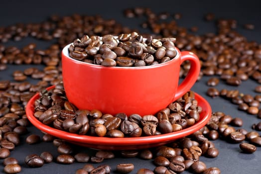 Cup on the saucer full of coffee beans