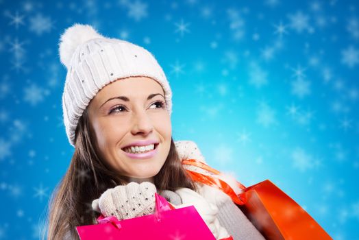 Happy young woman with her shopping bags