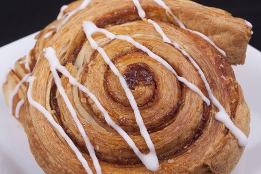 cinnamon danish  on white plate.