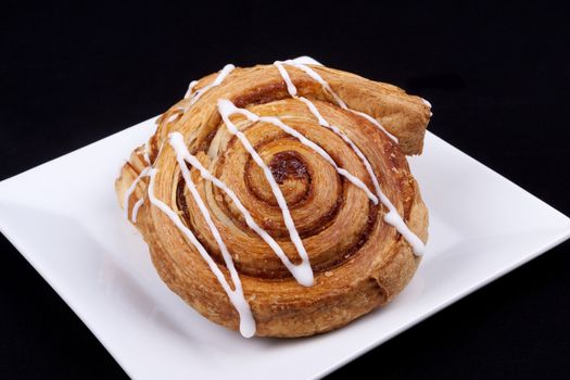 cinnamon danish  on white plate.